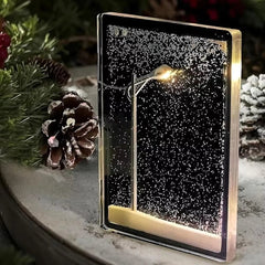 Kit DIY de lámpara de nieve con farola LED sobre una mesa decorada